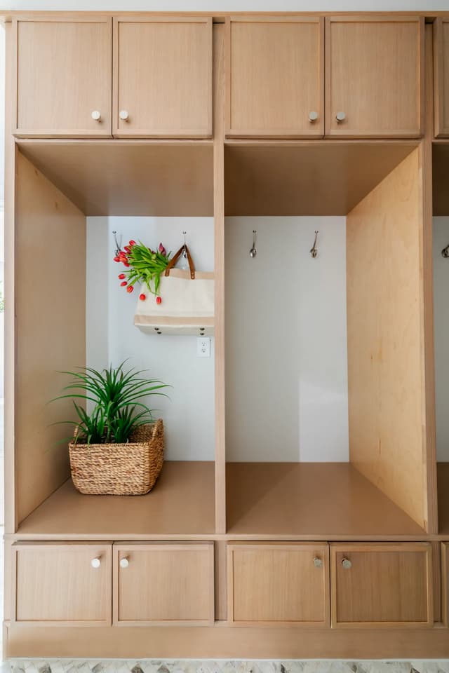Natural oak mudroom cabinetry with open landing spaces
