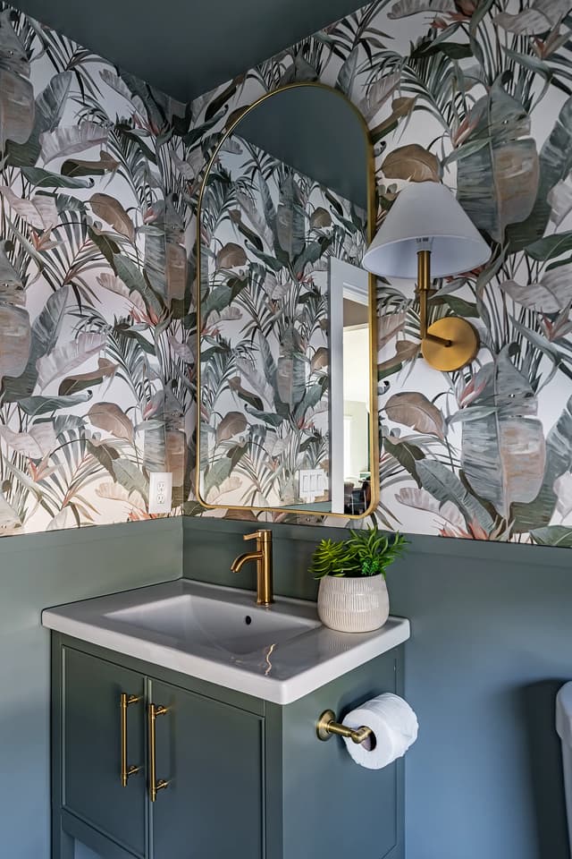 Coordinating green powder room vanity with botanical wallcovering