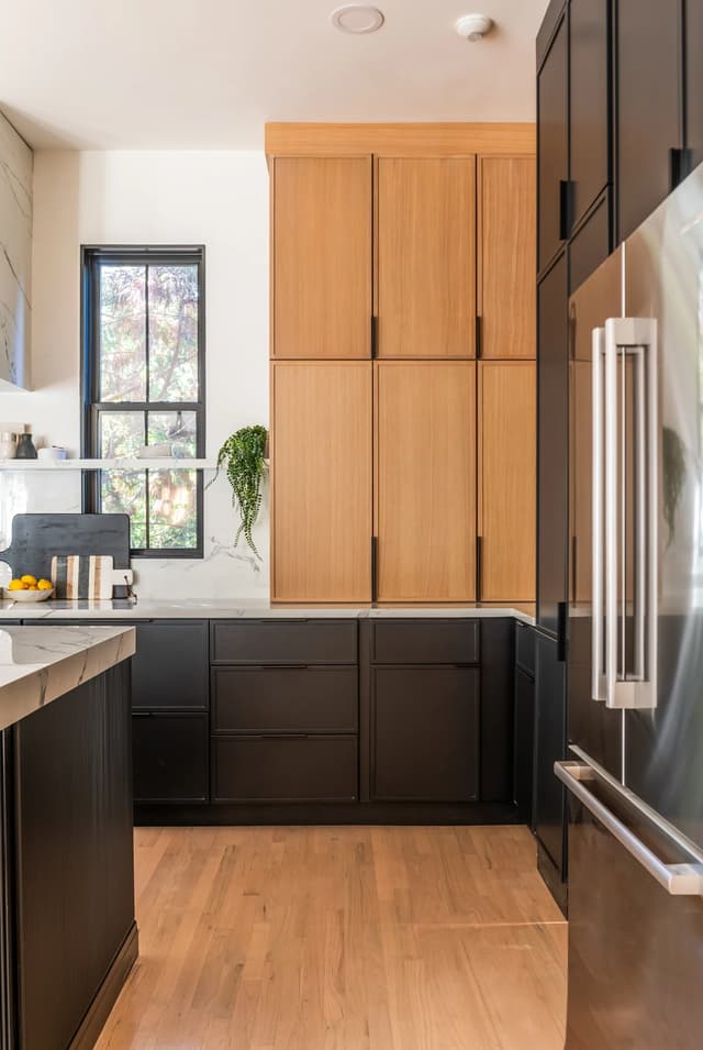 Natural oak cabinetry meeting full-height charcoal storage