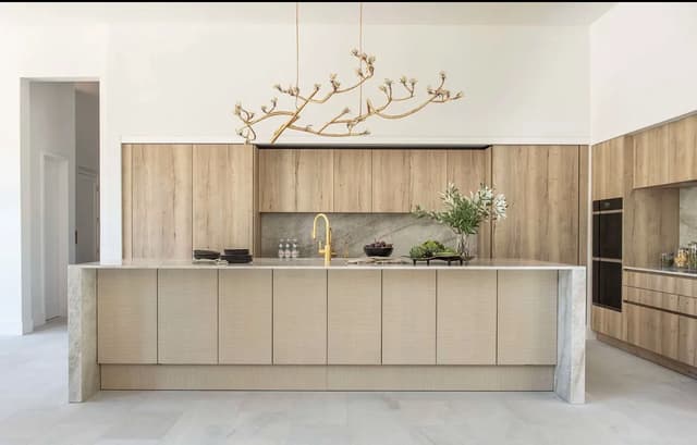 Minimal light oak kitchen with a monolithic stone island