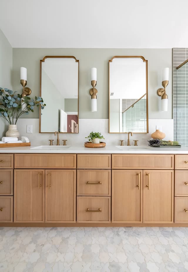 Detailed view of the oak vanity, stone surface, and brass fixtures