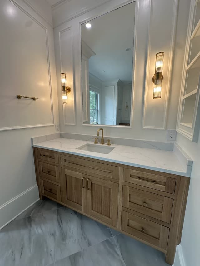 Warm oak bathroom cabinetry and stone surfaces