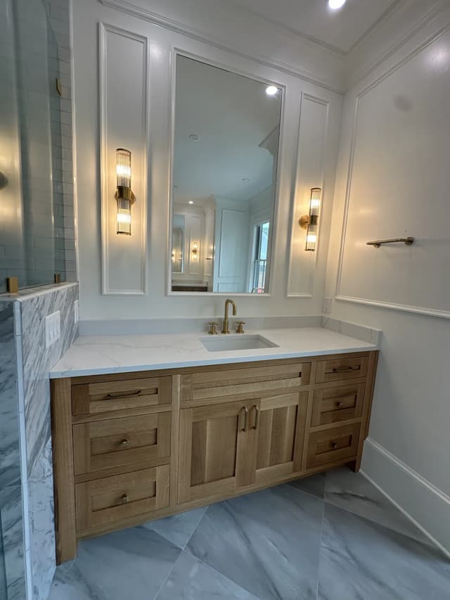 Coordinating warm oak vanity with brass details