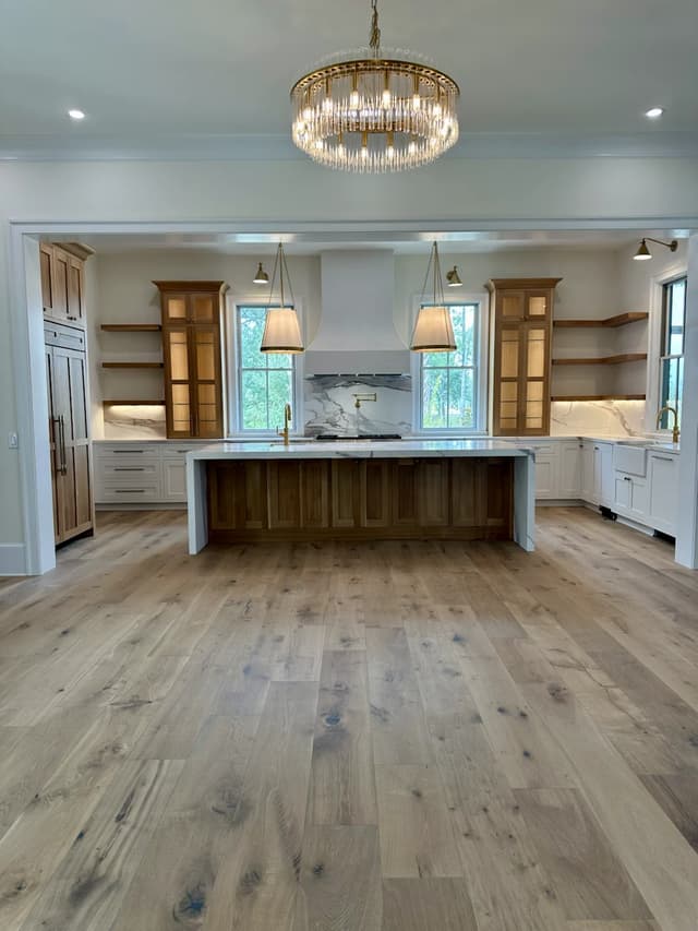 Wide view of the warm oak kitchen and Italian marble island